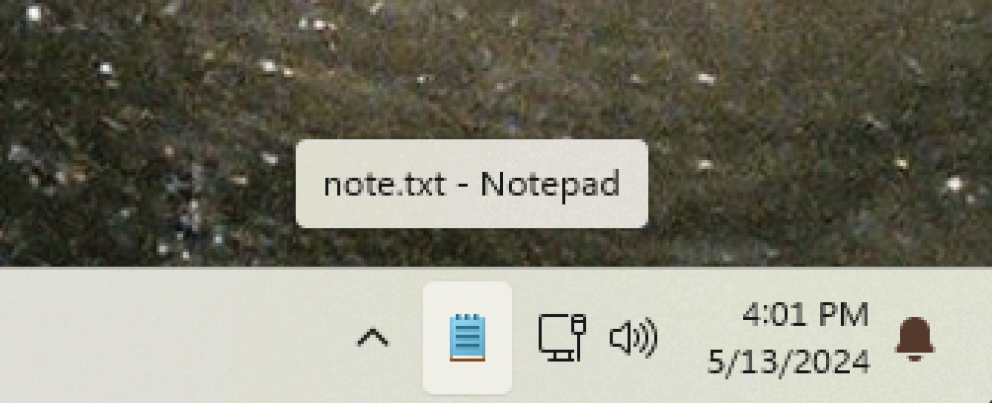 The notepad icon is visible in the system tray—the tooltip says "note.txt — Notepad".